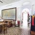 Granny's Inn Hostel in Sliema: shared kitchen and dining area with table, sofa, and large wall art
