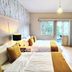 Casa Panuco in Mexico City guest room with two beds, balcony view, desk and modern seating