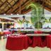 Buffet dining area at Voi Amarina Resort in Nosy Be with red table linens and tropical palm decor