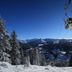 Chalet Hotel Régina in Les Gets with a ski lift over snowy alpine mountains and forest