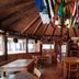 Cabañas Bordenieve in Termas de Chillan, rustic lodge dining room with wood walls and hanging flags