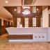 Hotel Yois Udaipur lobby reception desk with staff member and decorative wall panels