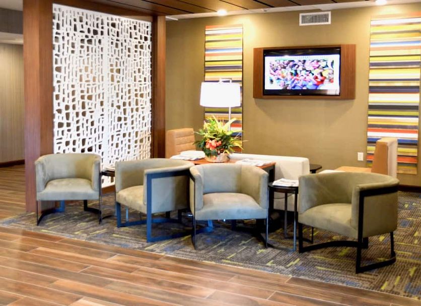 Holiday Inn Express Bordentown - Trenton South lobby seating area with chairs and wall-mounted TV
