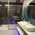 Iris Hotel Erbusco modern bathroom with walk-in shower, wall-mounted toilet and sink