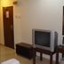 Jb City Hotel Johor Bahru guest room with TV, desk, chair and mirror