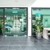 OYO 90151 Hill Inn Batu Caves entrance with glass doors, potted plants, and tiled walkway