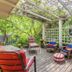 The Stella Rose B&B in Wolfville: shaded outdoor deck with lounge chairs, pergola, and blooming flowers