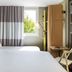 ibis Paris Saint-Denis Stade Sud guest room with twin beds, window and compact desk in La Plaine-Saint-Denis