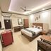 Hotel Chevron International, Ludhiāna room with double bed, desk, chair, wardrobe and ceiling fan