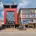 Hotel Golden Treat in Indore, modern red-front hotel exterior with glass entrance and street parking