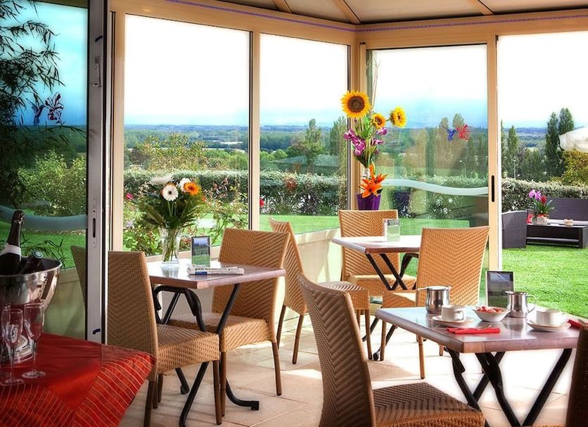 Hotel Le Kolibri in Tournus terrace dining room with panoramic countryside views