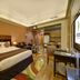 Al Khoory Hotel Apartments Al Barsha in Dubai: studio room with king bed, kitchenette, and seating area