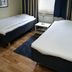 Hotel Göingehof in Hässleholm twin room with two single beds, window, and bedside table