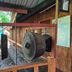 Kinabalu Poring Vacation Lodge in Kundasang with hanging gongs on a wooden porch