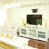 Landhotel Christopherhof in Grafenwiesen living room with white sofa, TV console and ornate chair