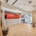 Hakuba Gondola Hotel in Hakuba lobby with front desk, seating area, and glass entrance
