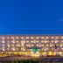 La'gent Hotel Okinawa Chatan in Chatan at night, with lit balconies and a palm-lined frontage
