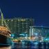 Radisson Blu Hotel, Dubai Deira Creek waterfront view with lit boats and Dubai skyline at night