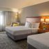 Courtyard by Marriott Cleveland Beachwood guest room with two beds, desk, chair and large window in Beachwood