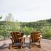 Hampton Inn By Hilton Elliot Lake balcony with two wooden chairs and forest views