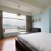 Light Morning in Yuchi Township: guest room with bed and large window overlooking lake and mountains