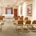 Holiday Inn Express & Suites Kerrville meeting room with rows of chairs and front table