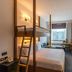 Studio One Hotel Dubai room with bunk bed, desk and city view through window