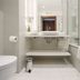 Qubus Hotel Bydgoszcz bathroom with vanity, bathtub, toilet, and white tiled floor