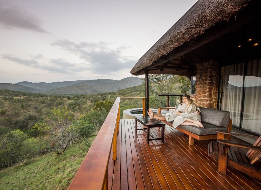 Leopard Mountain Safari Lodge in Hluhluwe with private deck, lounge chairs and sweeping safari views