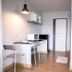 Vanilla Residence Chiangmai room with kitchenette, desk, shelving and wood flooring in Chiang Mai