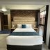 Logan City Motor Inn room in Slacks Creek with queen bed, brick accent wall and large window