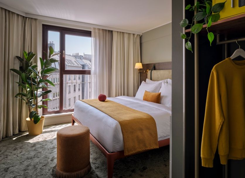 pentahotel Vienna guest room with king bed, floor-to-ceiling window, and city view