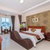 Queen Garden Hotel & Apartment room in Vung Tau with bed, seating area and city view