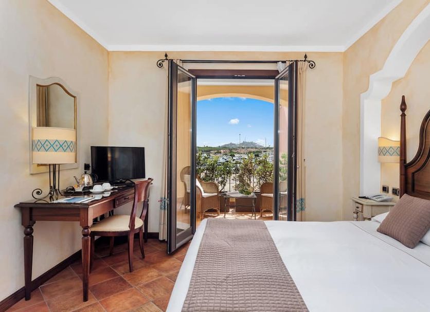 La Vecchia Fonte, Palau: hotel room with balcony doors open to sea view and outdoor seating