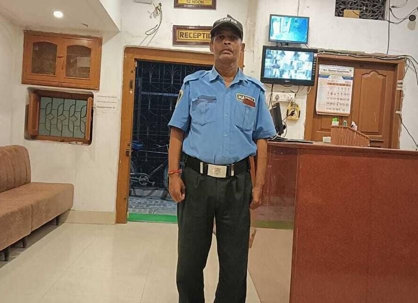 Scindhia Guest House in Varanasi lobby with a security guard at the reception desk