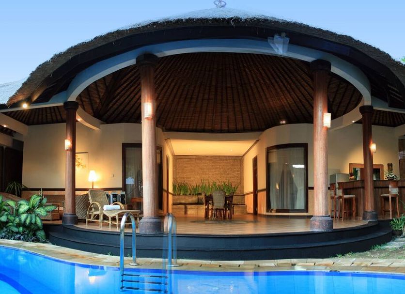The Taman Ayu in Kuta: tropical villa with curved roof, pool, and open-air patio