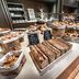 Breakfast buffet at Steigenberger Hotel Treudelberg in Hamburg with pastries, breads and sweet rolls