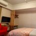 Sin Fu Business Hotel, Taichung City guest room with bed, TV, desk and air conditioner