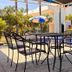 Hotel Cascada Cuautla outdoor patio with table, chairs, umbrella and poolside seating