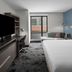 Hyatt House Raleigh Downtown/Seaboard Station guest room with bed, desk, TV and city-view window