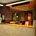 Rayentray Grand Hotel in Puerto Madryn lobby with Buddha statue and warm reception desk