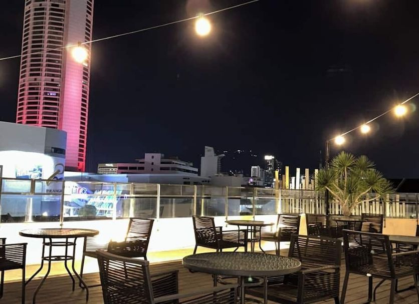 Le Dream Boutique Hotel rooftop terrace in George Town with string lights, tables, chairs and city views