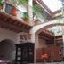 Hotel del Vasco in Zacatecas interior courtyard with arches, potted plants, and wooden balconies