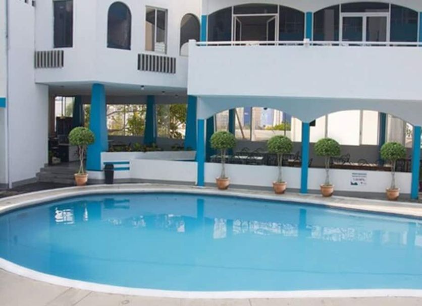 Dorados Acapulco in Acapulco with a curved outdoor swimming pool and blue-accented patio area