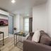 Citadines Sukhumvit 16 Bangkok apartment with sofa, desk, wall TV, and floor-to-ceiling window in Bangkok