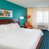 Fairfield Inn & Suites by Marriott South Bend Mishawaka guest room with king bed, TV, desk and chair in Mishawaka