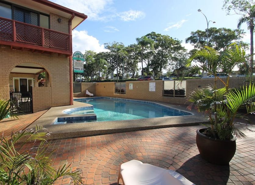 Toreador Motel in Coffs Harbour with outdoor pool and brick courtyard beside guest rooms