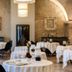 Chateau de Saulon dining room in Saulon-la-Rue with round tables set under arched stone ceilings