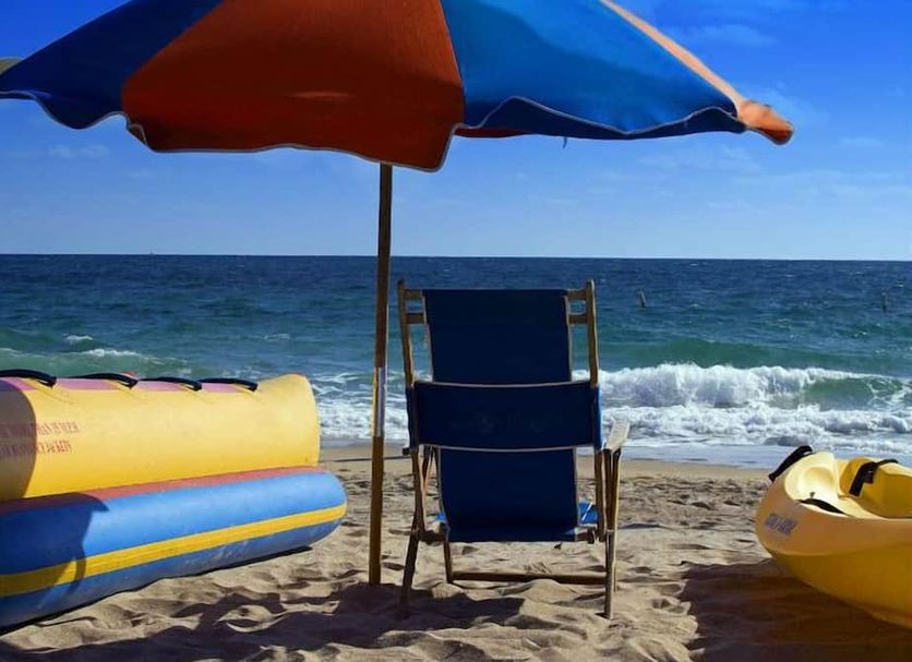 Club Wyndham Sea Gardens beach scene in Pompano Beach with chair, umbrella, and ocean waves