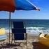 Club Wyndham Sea Gardens beach scene in Pompano Beach with chair, umbrella, and ocean waves